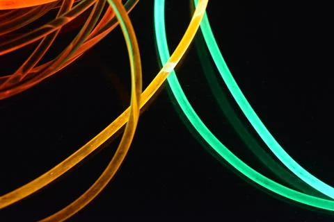 Color motion blurred magic neon red, blue, green, yellow light circles, lines. Stock Photos