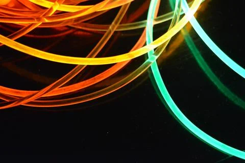 Color motion blurred magic neon red, blue, green, yellow light circles, lines. Stock Photos