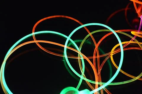 Color motion blurred magic neon red, blue, green, yellow light circles, lines. Stock Photos