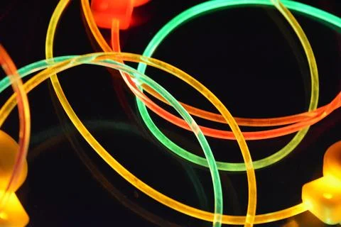 Color motion blurred magic neon red, blue, green, yellow light circles, lines. Stock Photos