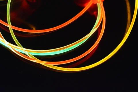 Color motion blurred magic neon red, blue, green, yellow light circles, lines. Stock Photos