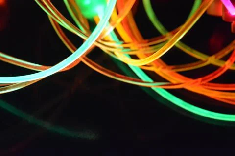Color motion blurred magic neon red, blue, green, yellow light circles, lines. Stock Photos