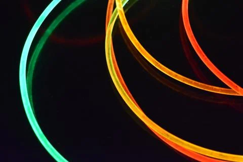 Color motion blurred magic neon red, blue, green, yellow light circles, lines. Stock Photos