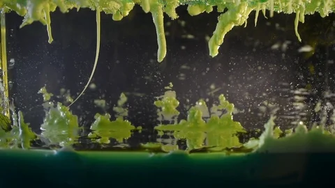 Color oil drops creating alien landscape with tornado forming and tearing Stock Footage 107301229