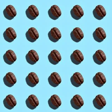 Color pattern of coffee beans on a blue background.  Top view. Fat lay. Stock Photos