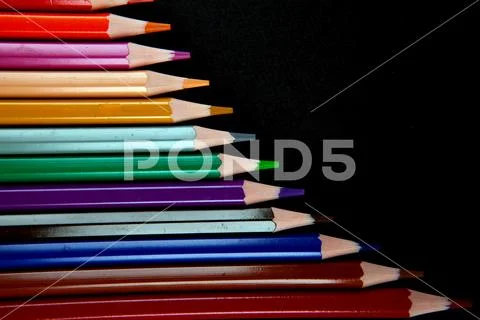 Color pencils on black background Stock Photos
