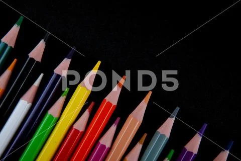 Color pencils on black background Stock Photos