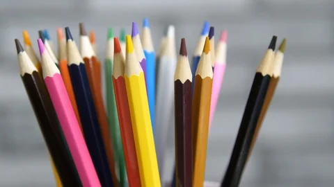 Color pencils rotating on a grey background Stock Footage 88920599