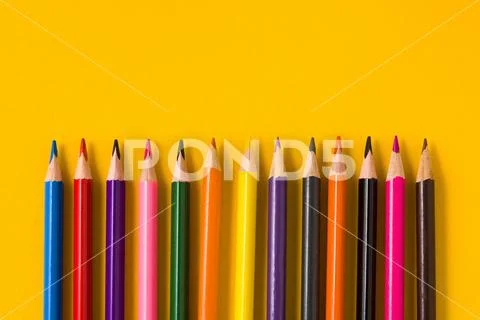 Color pencils on yellow background. Copyspace Stock Photos