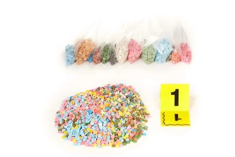 Color pills of MDMA, E, X seized by police to drug dealers Stock Photos