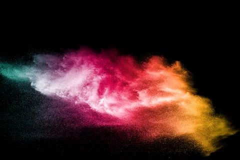 Color powder explosion cloud isolated on black background. Stock Photos