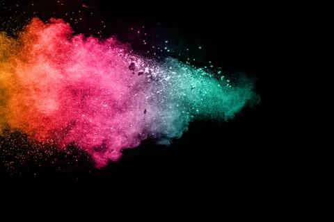Color powder explosion cloud isolated on black background. Stock Photos