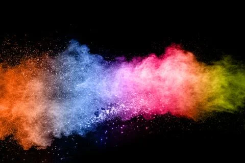Color powder explosion cloud isolated on black background. Stock Photos