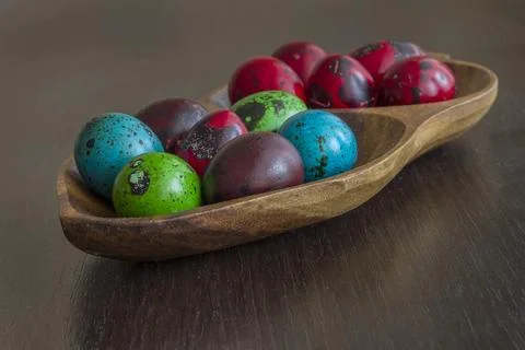 Color quail eggs for holiday easter in a bowl on the table Stock Photos