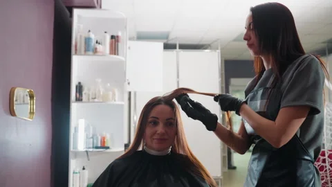 Color specialist uses precise techniques for hair coloring, professional hair Stock Footage 330604409