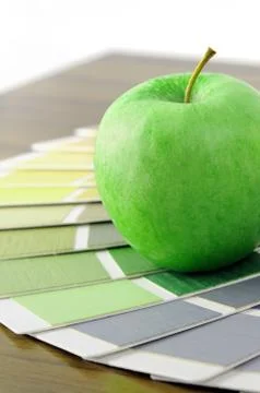 Color swatch on a table with apple Stock Photos