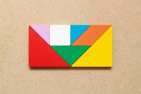 Color tangram puzzle in rectangle shape on wood background Stock Photos