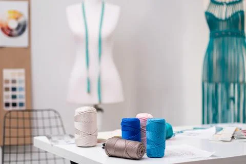 Color threads bobbins set for macrame dress on table in fashion shop sewing Stock Photos