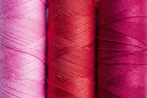 Color threads pink, red and ruby thread spoils closeup Copyright: xZoonar.... Stock Photos