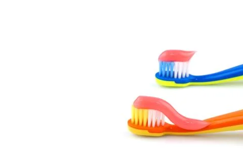 Color toothbrushes with pink toothpaste Stock Photos