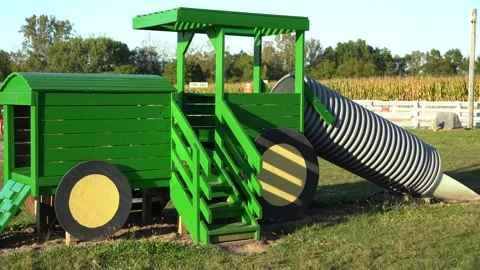 Color tractor play set with slide at the local pumpkin patch. Stock Footage 319639797