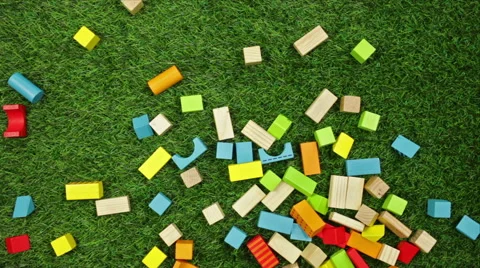 Color wooden blocks falling on the grass Stock Footage 48700701