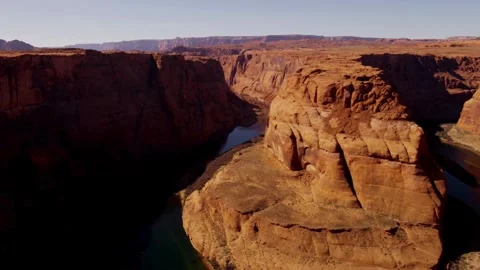 Colorado River flows through steep red rock canyon walls Stock Footage 329762277