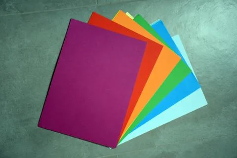 Colored a4 sheets on gray background violet color Foto stock