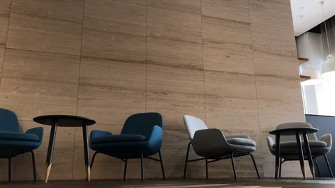Colored armchairs and small tables in office area Stock Footage 99468130