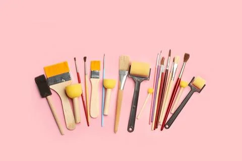 Colored artistic paintbrushes, roller brushes and sponge foam brushes Stock Photos
