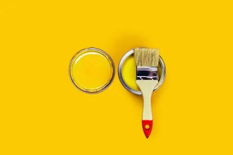 Colored background with paint jar and brush. Stock Photos