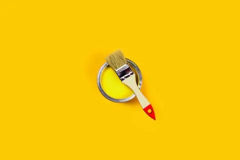 Colored background with paint jar and brush. Stock Photos
