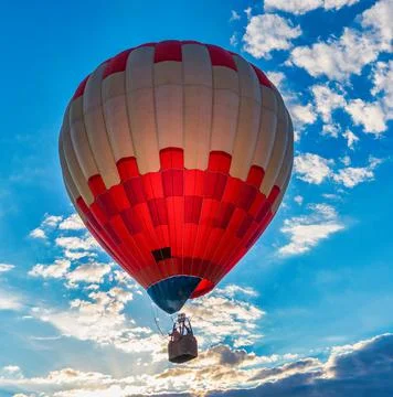 Colored balloon on the background of the colored sky. Stock Photos