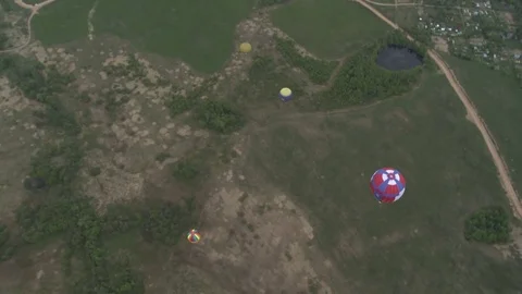 Colored balloon flying over field aerial short Stock Footage 73818133