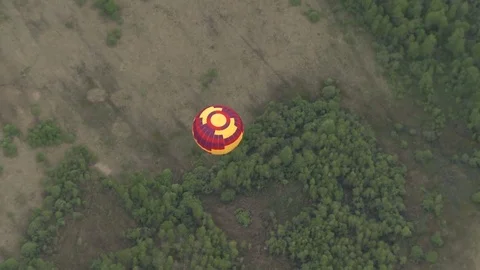 Colored balloon flying over forest aerial short Stock Footage 72200468