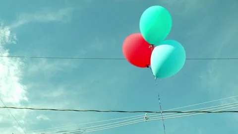 Colored Balloons On a String Up against a Blue Sky  Stock Footage 79606830