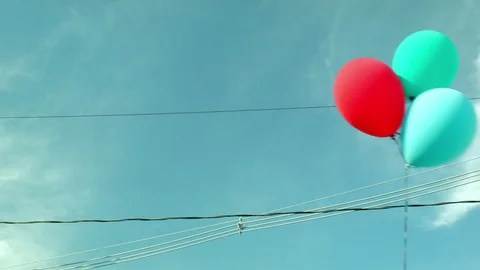 Colored Balloons On a String Up against a Blue Sky  Stock Footage 79606888