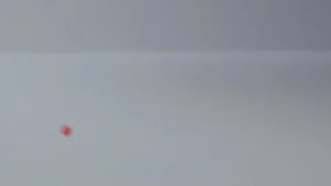 Colored balls of confectionery dressing fall on the table in slow motion video Stock Footage 107723982