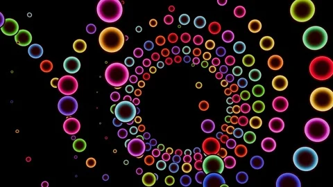 Colored balls spiral on a black background in a seamless loop. 스톡 동영상 288321486