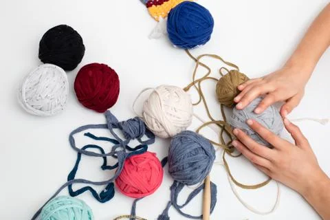 Colored balls of yarn on white table Stock Photos