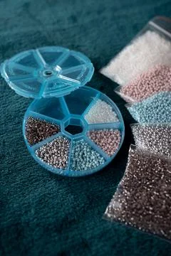 Colored beads in a transparent container Stock Photos