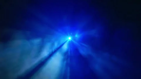 Colored beams emerge from the central white point and move on a black background Stock Footage 313147177