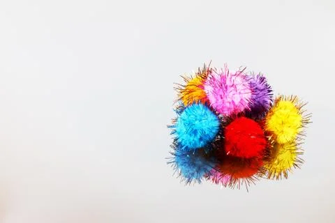 Colored beautiful pompons on a gray background Stock Photos