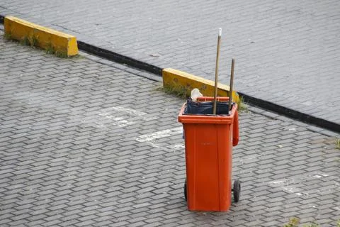 Colored bins of garbage collection workers Stock Photos