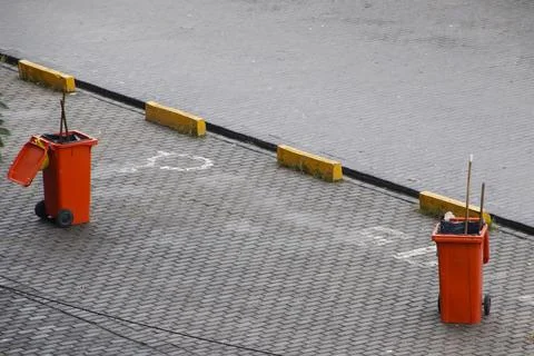 Colored bins of garbage collection workers Stock Photos
