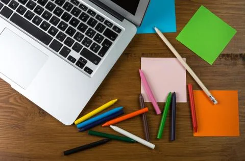 Colored blank post-it with office supplies on wooden table. Stock Photos