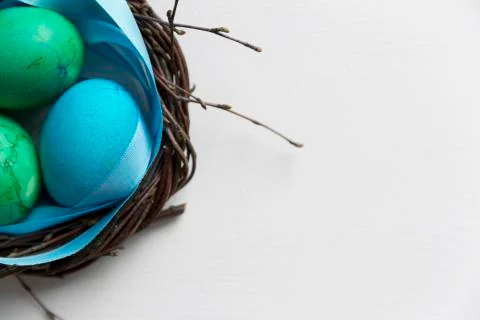 Colored blue easter eggs in twig nest. Happy easter concept. Greeting card Stock Photos