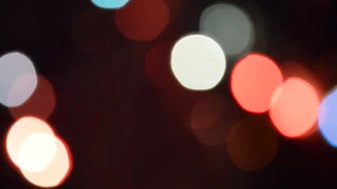 Colored bokeh on a black background. flashing lights of the garland. decoration Stock Footage 299291403