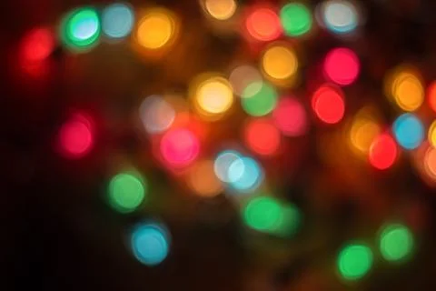 Colored bokeh on dark background . Stock Photos