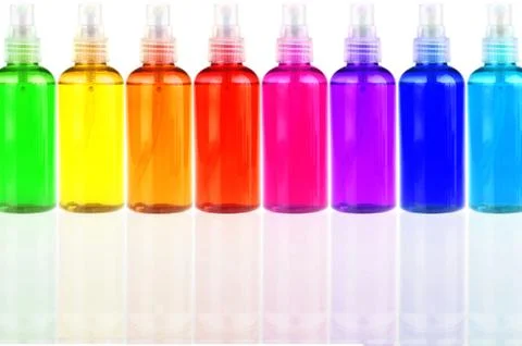 Colored bottles with cosmetics in a row Stock Photos